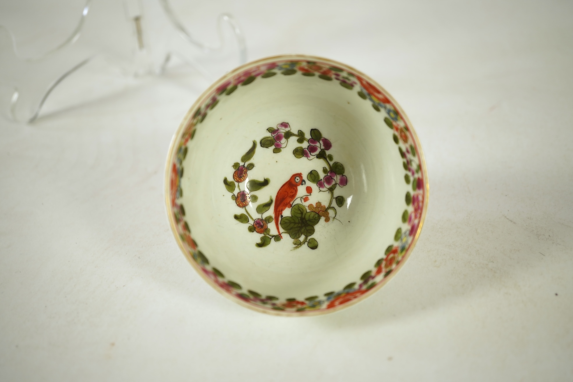 A Worcester Old Worcester Parrot pattern tea bowl and saucer, c.1765-68, saucer 11.5cm in diameter